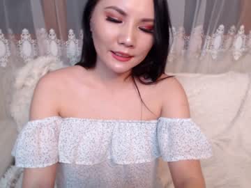 Petite Asian wife dildos her trimmed pussy during a live sex show